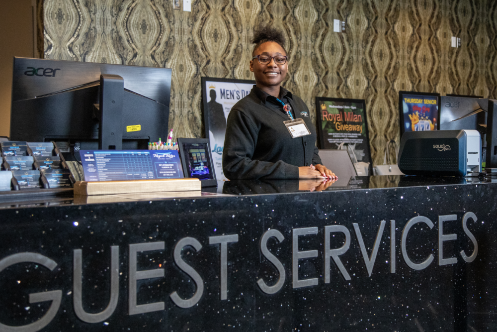 Guest Services Area with Smiling Worker Behind the Counter